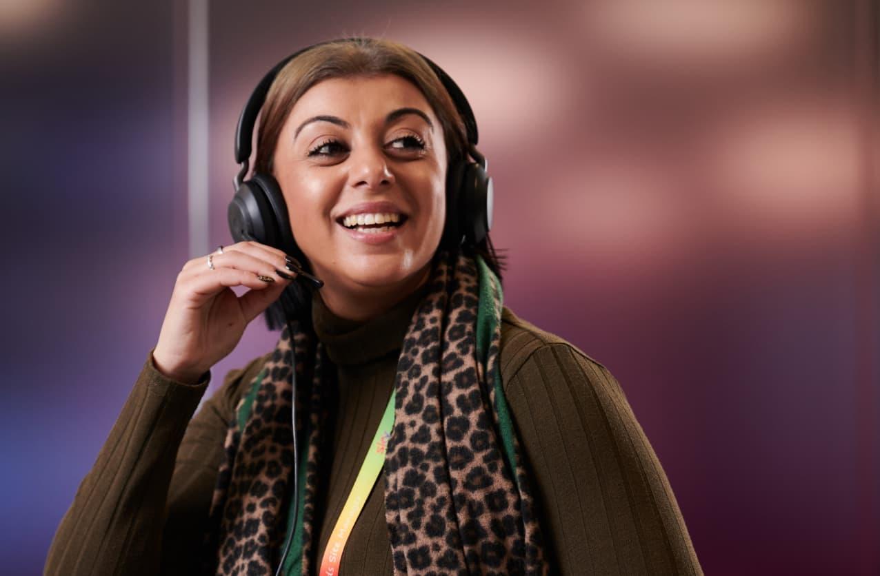 woman in a headset smiling